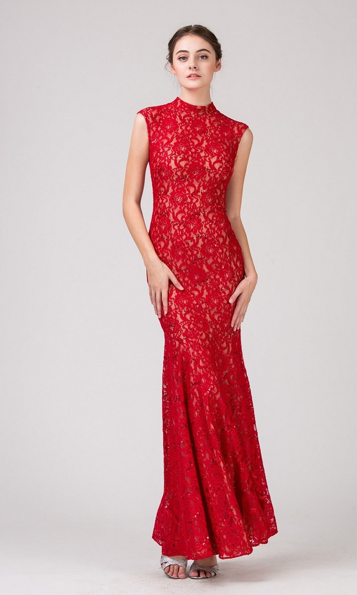 A woman poses against a plain background wearing the Eureka 2061 Long Lace Formal Dress in Red/Gold and silver open-toe heels.